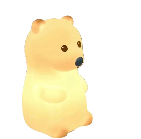 Bear-shaped night light emitting a warm glow on a dark background